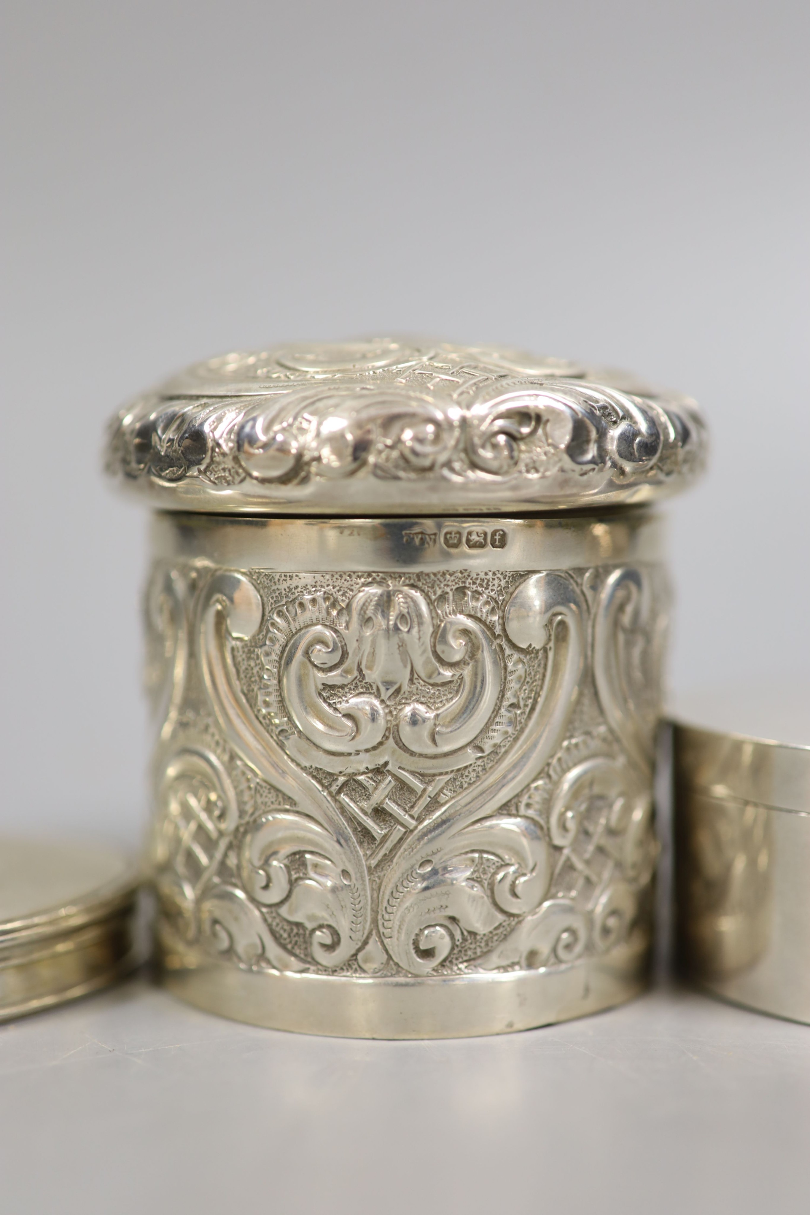 A Georgian silver snuff box of oval form, together with a small tea strainer and three other silver boxes, 10.5oz.